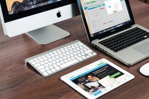 Apple devices on a wooden desk