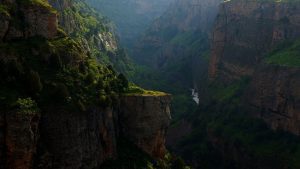 Lush green valley with steep cliffs